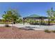 Park pavilion with picnic tables, surrounded by trees and landscaped areas at 7931 Mineral Peak St, Las Vegas, NV 89166