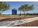Park entrance sign with landscaping and walking path leading to grassy fields at 7931 Mineral Peak St, Las Vegas, NV 89166