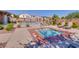 Community pool and spa area with lounge chairs and manicured landscaping offers a relaxing oasis at 7931 Mineral Peak St, Las Vegas, NV 89166