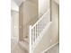 Carpeted staircase with white railing and neutral-toned walls in the home's interior at 7931 Mineral Peak St, Las Vegas, NV 89166