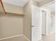 A simple walk-in closet provides an organized solution for storage, with a hanging rod and carpeted floor at 7931 Mineral Peak St, Las Vegas, NV 89166