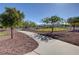 Paved walking path winds through a grassy park area near the dog park at 7931 Mineral Peak St, Las Vegas, NV 89166