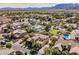 Residential neighborhood with lush tree coverage showcasing well-maintained homes, swimming pools and green spaces at 7947 Lookout Rock Cir, Las Vegas, NV 89129