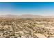 An aerial view presents a vast suburban landscape framed by distant mountain ranges at 7947 Lookout Rock Cir, Las Vegas, NV 89129