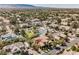 A diverse residential area featuring private pools, mature trees, and landscaped yards, nestled near the mountains at 7947 Lookout Rock Cir, Las Vegas, NV 89129