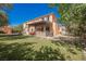 Inviting backyard featuring a covered patio with stone accents and a grill at 7947 Lookout Rock Cir, Las Vegas, NV 89129
