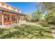 Lush backyard showcasing a green lawn, pergola-covered patio, and mature landscaping at 7947 Lookout Rock Cir, Las Vegas, NV 89129