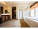 Large bathroom with dual vanities, soaking tub, shower, and separate toilet room at 7947 Lookout Rock Cir, Las Vegas, NV 89129