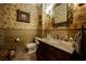 Charming bathroom featuring decorative wallpaper, an ornate mirror, and an antique-style vanity with marble countertop at 7947 Lookout Rock Cir, Las Vegas, NV 89129