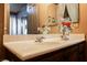 Bathroom vanity features white countertop, modern faucet and decorative accents at 7947 Lookout Rock Cir, Las Vegas, NV 89129