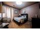 Cozy bedroom featuring neutral tones, patterned wallpaper, and stylish decor at 7947 Lookout Rock Cir, Las Vegas, NV 89129