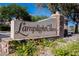 Elegant community entrance sign surrounded by lush landscaping and flowers at 7947 Lookout Rock Cir, Las Vegas, NV 89129