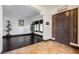 Beautiful foyer showcases tile flooring, a dark wood door, shutters, and plants adding a touch of nature at 7947 Lookout Rock Cir, Las Vegas, NV 89129