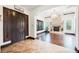 Bright foyer boasts tile flooring, dark wood trim, shutters, and an elegant archway leading to the living space at 7947 Lookout Rock Cir, Las Vegas, NV 89129