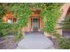 Welcoming front entrance framed by lush greenery and manicured landscaping at 7947 Lookout Rock Cir, Las Vegas, NV 89129