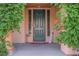 Charming front entrance with a dark green door, adorned with climbing vines at 7947 Lookout Rock Cir, Las Vegas, NV 89129
