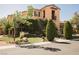 Beautiful two-story home with lush greenery, decorative trees and inviting landscape at 7947 Lookout Rock Cir, Las Vegas, NV 89129