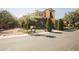 Inviting two-story home with manicured lawn, mature trees, and stone accents at 7947 Lookout Rock Cir, Las Vegas, NV 89129