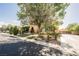 Lovely landscaped yard with mature trees, fountain, gated driveways and a charming home at 7947 Lookout Rock Cir, Las Vegas, NV 89129