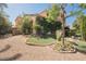 A charming home featuring decorative landscaping, a fountain, and a gated driveway at 7947 Lookout Rock Cir, Las Vegas, NV 89129