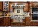 Gourmet kitchen showcasing stainless steel appliances, granite countertops, and custom cabinetry at 7947 Lookout Rock Cir, Las Vegas, NV 89129