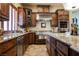 Gourmet kitchen showcasing stainless steel appliances, granite counters, and custom cabinetry at 7947 Lookout Rock Cir, Las Vegas, NV 89129