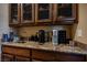 Convenient coffee bar with custom cabinets and granite countertops is perfect for entertaining or a quick pick-me-up at 7947 Lookout Rock Cir, Las Vegas, NV 89129