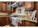 Gourmet kitchen features granite countertops, stainless steel appliances, and custom cabinetry at 7947 Lookout Rock Cir, Las Vegas, NV 89129