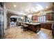 Open kitchen and breakfast nook features granite island, stainless steel appliances, and tiled flooring at 7947 Lookout Rock Cir, Las Vegas, NV 89129