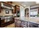 Gourmet kitchen showcasing stainless steel appliances, granite countertops, island with sink, and custom cabinetry at 7947 Lookout Rock Cir, Las Vegas, NV 89129