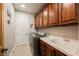 Laundry room featuring upper and lower cabinets, a sink, and appliances at 7947 Lookout Rock Cir, Las Vegas, NV 89129