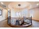 Grand curved staircase with decorative iron railings leads to a bright landing with arched windows and stylish lighting at 7947 Lookout Rock Cir, Las Vegas, NV 89129