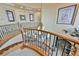 Curved staircase features wrought iron railing, chandelier, and large windows offering abundant natural light on the upper level at 7947 Lookout Rock Cir, Las Vegas, NV 89129