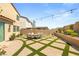 Outdoor patio area featuring a built-in fountain, dining set, and beautiful pavers surrounded by turf at 812 Stannard Ct, Henderson, NV 89052