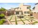 Spacious backyard with paved patio, green turf accents, mature landscaping, and outdoor dining area at 812 Stannard Ct, Henderson, NV 89052