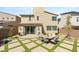 Spacious backyard with a custom brick and turf patio featuring an outdoor dining set at 812 Stannard Ct, Henderson, NV 89052