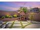 Cozy backyard showcasing a fireplace and brick patio under string lights at 812 Stannard Ct, Henderson, NV 89052