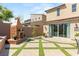 Charming backyard with a brick and turf patio, an outdoor fireplace, and plenty of room to relax at 812 Stannard Ct, Henderson, NV 89052