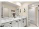 Bright bathroom featuring a double sink vanity, a large mirror, and a shower and bathtub combo at 812 Stannard Ct, Henderson, NV 89052