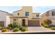 Charming home with an arched doorway, two-car garage, and well-manicured landscaping at 812 Stannard Ct, Henderson, NV 89052