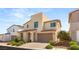 Inviting exterior featuring an arched doorway, two-car garage, and desert-friendly landscape at 812 Stannard Ct, Henderson, NV 89052