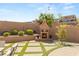 Outdoor fireplace with lush landscaping and an expansive patio for luxury outdoor living and relaxation at 812 Stannard Ct, Henderson, NV 89052