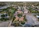 Stunning aerial view showcasing the property in a lush neighborhood with views of a horse training facility at 8130 Cassian Ct, Las Vegas, NV 89129