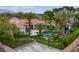 Expansive backyard with a sparkling pool, mature palm trees, and a basketball court at 8130 Cassian Ct, Las Vegas, NV 89129