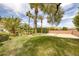 Lush backyard featuring mature trees, a well-maintained lawn, and a basketball court, ideal for outdoor activities and relaxation at 8130 Cassian Ct, Las Vegas, NV 89129