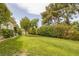 Expansive backyard with mature landscaping, lush lawn, and serene privacy at 8130 Cassian Ct, Las Vegas, NV 89129