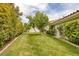 Spacious backyard featuring a lush lawn and mature trees, perfect for outdoor activities and relaxation at 8130 Cassian Ct, Las Vegas, NV 89129