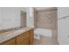 Bathroom featuring decorative tile, granite counters, bath tub, and a modern vanity at 8130 Cassian Ct, Las Vegas, NV 89129
