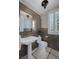 Stylish bathroom with a pedestal sink, marble floors, and decorative wall tiles at 8130 Cassian Ct, Las Vegas, NV 89129