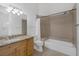 Bathroom featuring decorative tile, granite counters, bath tub, and a modern vanity at 8130 Cassian Ct, Las Vegas, NV 89129